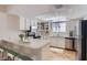 Well-lit kitchen featuring stainless steel appliances, white cabinets, and breakfast bar seating at 1963 Scimitar Dr # 0, Henderson, NV 89014