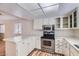 Bright kitchen featuring white cabinets, stainless steel appliances, and laminate flooring at 1963 Scimitar Dr # 0, Henderson, NV 89014