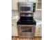 Close up of the stainless steel oven and microwave in a kitchen with white cabinets at 1963 Scimitar Dr # 0, Henderson, NV 89014