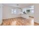 Open living space with adjacent kitchen featuring wood-look floors, a window, and neutral colored paint at 1963 Scimitar Dr # 0, Henderson, NV 89014