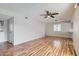 Open living space with a ceiling fan, light gray walls, and wood-look flooring adjacent to a sliding door at 1963 Scimitar Dr # 0, Henderson, NV 89014