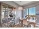 Elegant dining area with a glass-front cabinet and city views at 200 Sahara Ave # 1708, Las Vegas, NV 89102