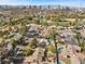 Aerial view showcasing a community near a golf course and city skyline at 2192 Geronimo Way, Las Vegas, NV 89169