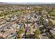 Aerial view of residential neighborhood with pools and green spaces, near mountains and a golf course at 2192 Geronimo Way, Las Vegas, NV 89169