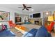 Mid century modern living room with stone fireplace and stylish furniture at 2192 Geronimo Way, Las Vegas, NV 89169