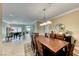 Bright dining room with a large table, seating for eight and neutral color palette at 2373 Rosendale Village Ave, Henderson, NV 89052