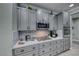 Kitchen detail showing gray cabinets, marble countertops, and stainless steel appliances at 2373 Rosendale Village Ave, Henderson, NV 89052