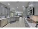 Open concept kitchen boasting modern gray cabinets and marble countertops at 2373 Rosendale Village Ave, Henderson, NV 89052