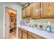 Laundry room with utility sink, storage, and shelving at 2373 Rosendale Village Ave, Henderson, NV 89052