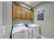 Bright laundry room, washer, dryer, and ample cabinetry at 2373 Rosendale Village Ave, Henderson, NV 89052