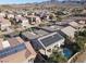 Aerial view showcasing a house with solar panels, pool, and surrounding neighborhood at 2423 Blair Castle St, Henderson, NV 89044