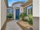 Inviting front entrance with a blue door and well-manicured landscaping at 2423 Blair Castle St, Henderson, NV 89044