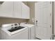 Laundry room with washer, dryer, and overhead cabinets at 2423 Blair Castle St, Henderson, NV 89044