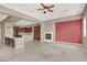 Living room with a fireplace, kitchen views, and a red accent wall at 2423 Blair Castle St, Henderson, NV 89044