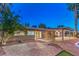 Landscaped backyard with stone patio and covered seating area at 2505 Laurie Dr, Las Vegas, NV 89102