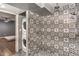 Bathroom with patterned tile shower and stackable laundry at 2505 Laurie Dr, Las Vegas, NV 89102