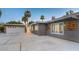 Gray mid-century modern home with white garage door and landscaping at 2505 Laurie Dr, Las Vegas, NV 89102