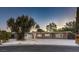 Stunning exterior of a remodeled mid-century modern home with a large driveway at 2505 Laurie Dr, Las Vegas, NV 89102