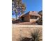 Tan colored house with a tile roof and small front yard at 2567 Paradise Village Way, Las Vegas, NV 89120