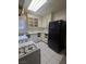 Kitchen with white cabinets, gas stove, and black refrigerator at 2567 Paradise Village Way, Las Vegas, NV 89120