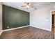 Bedroom with wood-look floors, neutral walls, and ceiling fan at 2905 Carothers Ct, North Las Vegas, NV 89032