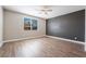 Spacious bedroom with wood-look flooring and ceiling fan at 2905 Carothers Ct, North Las Vegas, NV 89032