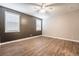 Bedroom with dark accent wall and two windows at 2905 Carothers Ct, North Las Vegas, NV 89032