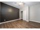 Bedroom with dark accent wall and ceiling fan at 2905 Carothers Ct, North Las Vegas, NV 89032