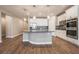 Modern kitchen with white cabinets, granite counters, and stainless steel appliances at 2905 Carothers Ct, North Las Vegas, NV 89032