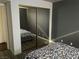 Bright bedroom with mirrored closet doors and floral bedding at 2962 Juniper Hills Blvd # 203, Las Vegas, NV 89142