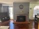 Living room fireplace with a gray stone mantel and dark hardwood floors at 2962 Juniper Hills Blvd # 203, Las Vegas, NV 89142