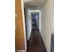 Bright hallway with dark hardwood floors and access to bedrooms at 2962 Juniper Hills Blvd # 203, Las Vegas, NV 89142