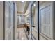 Long bathroom hallway with mirrored walls and tiled flooring at 30 Via Mantova # 108, Henderson, NV 89011