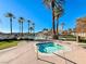 Inviting hot tub surrounded by palm trees and landscaping at 30 Via Mantova # 108, Henderson, NV 89011