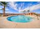 Community pool with palm trees and a relaxing patio area at 30 Via Mantova # 108, Henderson, NV 89011