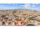 Aerial view of house and surrounding neighborhood in mountainous area at 3139 Ocotillo Dr, Laughlin, NV 89029