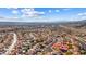 Wide aerial view of house, neighborhood, and distant city at 3139 Ocotillo Dr, Laughlin, NV 89029