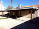 Covered patio, grassy area, and terraced retaining walls at 3139 Ocotillo Dr, Laughlin, NV 89029