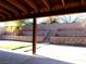 Covered patio overlooking a terraced backyard with stone retaining walls and stairs at 3139 Ocotillo Dr, Laughlin, NV 89029