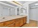 Double vanity bathroom with wood cabinets and access to a walk-in closet at 3139 Ocotillo Dr, Laughlin, NV 89029