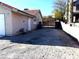 Side view of house showing gated access and a gravel area at 3139 Ocotillo Dr, Laughlin, NV 89029