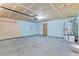 Unfinished garage with overhead door and water heater at 3139 Ocotillo Dr, Laughlin, NV 89029