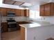 Galley kitchen with stainless steel appliances and wood cabinets at 3139 Ocotillo Dr, Laughlin, NV 89029