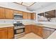 L-shaped kitchen with stainless steel appliances and wood cabinets at 3139 Ocotillo Dr, Laughlin, NV 89029