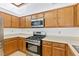 Kitchen area with stainless steel appliances and wood cabinets at 3139 Ocotillo Dr, Laughlin, NV 89029