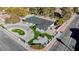 Aerial view showcasing home's exterior, landscaping, and pool at 3180 S Tioga Way, Las Vegas, NV 89117