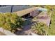 Backyard with covered patio, mature trees, and gravel landscaping at 3180 S Tioga Way, Las Vegas, NV 89117