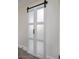 White barn door with frosted glass panels adds a touch of farmhouse style at 3180 S Tioga Way, Las Vegas, NV 89117