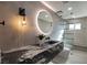 Contemporary bathroom with floating vanity and large mirror at 3180 S Tioga Way, Las Vegas, NV 89117