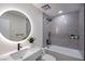 Modern bathroom with gray tile,freestanding tub, and a large vanity at 3180 S Tioga Way, Las Vegas, NV 89117